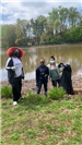 Volunteers Picking up Trash Beside the Lake