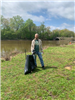 Man Standing Next to a Bag Full of Recovered Trash
